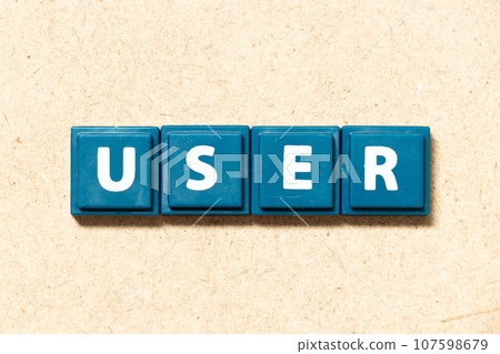 Tile alphabet letter in word user on wood background 107598679