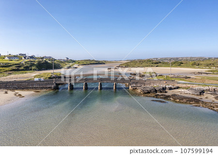 Aerial view of the bridge over the Atlantic to Cruit Island, County Donegal, Ireland 107599194