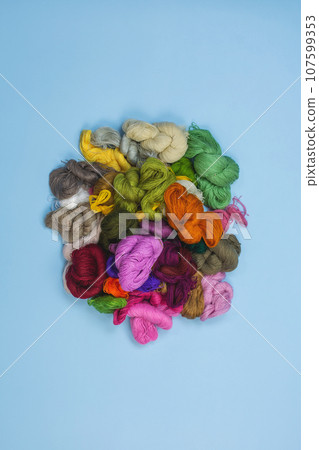 Mouline threads for embroidery displayed in a circle. Floss thread yarn. Small multicolored skeins of yarn. 107599353