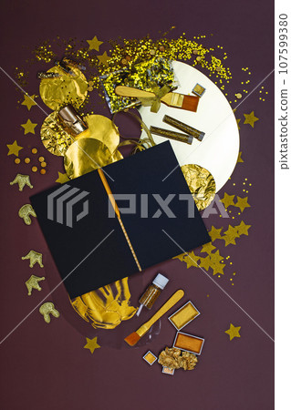 Notepad with black paper and golden stationery and items for creativity. Notebook black sketchbook mock up Notepad with black paper and golden stationery and items for creativity. Notebook black sketchbook mock up 107599380