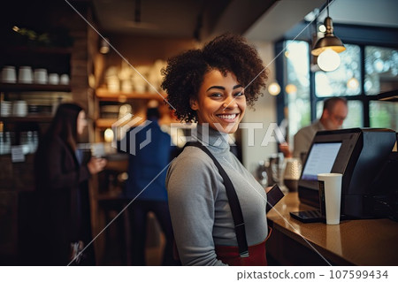 Cheerful female African American barista, standing at counter in coffee shop. Cheerful female African American barista, standing at counter in coffee shop. 107599434