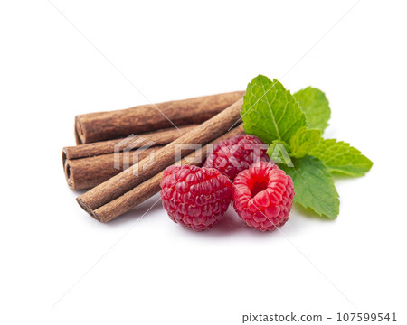Cinnamon stick with raspberry on white backgrounds 107599541