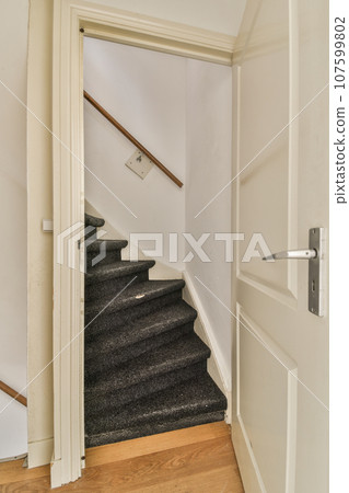 an empty room with stairs and a door leading to the second floor, which is in need of repair work 107599802