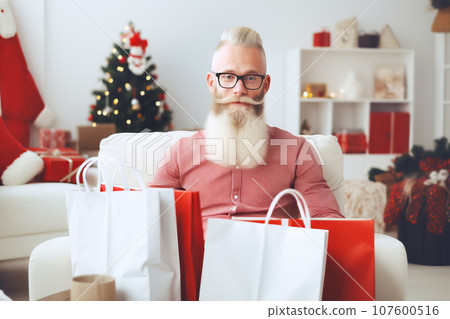 Attractive bearded man with lots of gifts for loved ones after Christmas shopping 107600516