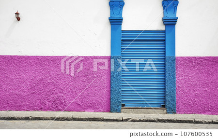 Street view of an old colonial building facade, architecture background, Cuenca, Ecuador. Street view of an old colonial building facade, architecture background, Cuenca, Ecuador. 107600535
