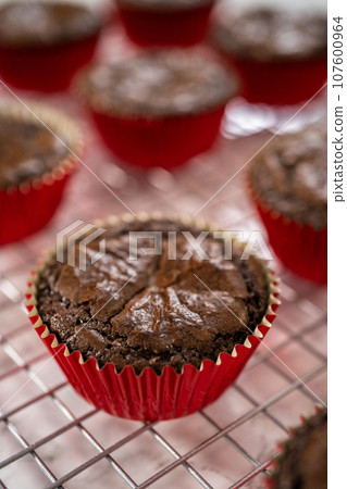 Cooling freshly baked chocolate peppermint cupcakes on a kitchen counter. 107600964