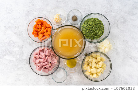 Flat lay. Measured ingredients in glass mixing bowls to make split pea soup. Flat lay. Measured ingredients in glass mixing bowls to make split pea soup. 107601038