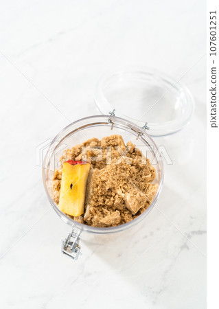 Making light brown sugar soft again with an apple core. Making light brown sugar soft again with an apple core. 107601251