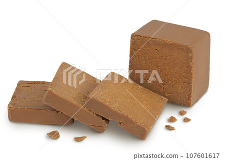 Brown cheese. Norwegian brunost isolated on white background with full depth of field Brown cheese. Norwegian brunost isolated on white background with full depth of field 107601617