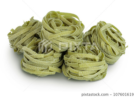 Raw tagliatelle green pasta with spinach isolated on white background 107601619