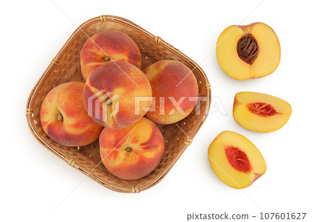 Ripe peach fruit with half in a wicker basket isolated on white background with full depth of field. Top view. Flat lay Ripe peach fruit with half in a wicker basket isolated on white background with full depth of field. Top view. Flat lay 107601627
