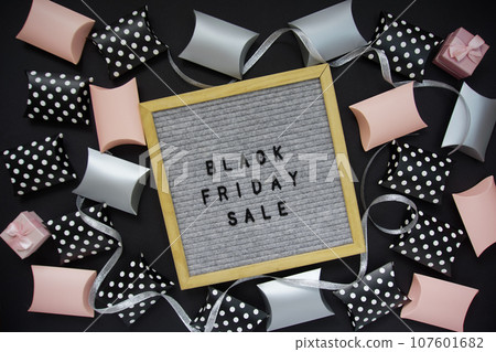 The inscription - black Friday sale in a frame, there are shopping boxes around The inscription - black Friday sale in a frame, there are shopping boxes around 107601682