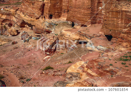 View of the Temples and caves carved into the sandstone rock in the gorge. Petra, Jordan 107601854