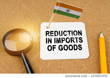 Economy and finance concept. On the table are a magnifying glass, a pencil, the flag of India and a sheet of paper with the inscription - reduction in imports of goods. Economy and finance concept. On the table are a magnifying glass, a pencil, the flag of India and a sheet of paper with the inscription - reduction in imports of goods. 107601976