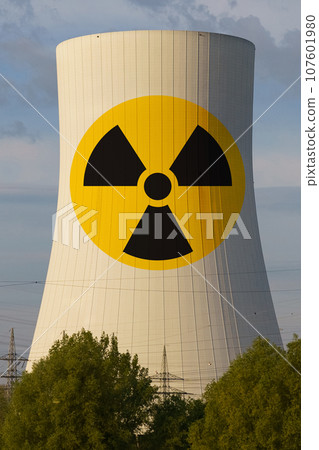 On the cooling tower of a nuclear power plant there is a sign - Beware of radiation. On the cooling tower of a nuclear power plant there is a sign - Beware of radiation. 107601980