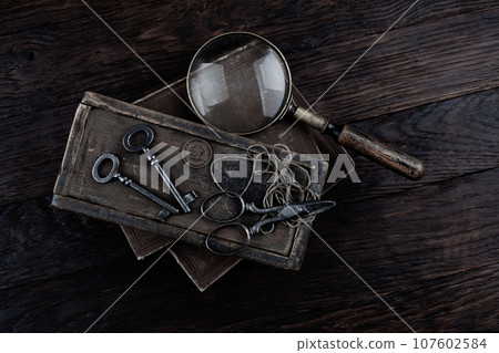 Antique wooden box, old vintage retro scissors and magnifying glass. Antique wooden box, old vintage retro scissors and magnifying glass. 107602584