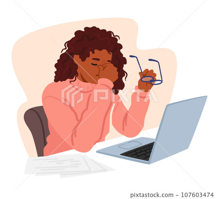 Young Woman In Office Attire Sits Front Of Pc At Desk Piled With Books, Holding Glasses In One Hand Rubbing Tired Eyes Young Woman In Office Attire Sits Front Of Pc At Desk Piled With Books, Holding Glasses In One Hand Rubbing Tired Eyes 107603474