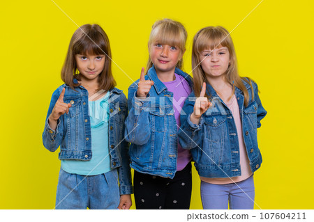 Displeased three girls children gesturing hands with irritation, quarrel, asking why this happened 107604211