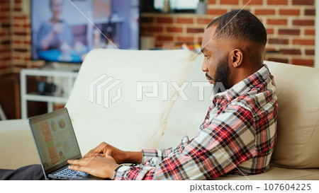 Remote employee using online analytics statistical data charts to identify trends and predict business outcomes. while working from home. Teleworker monitorizing market key performance indicators Remote employee using online analytics statistical data charts to identify trends and predict business outcomes. while working from home. Teleworker monitorizing market key performance indicators 107604225