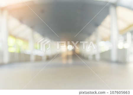 Blurry off white Backdrop hospital bright softness hotel with copy space. White Blurred background bright restaurant shopping mall Silver gray lighting. defocused store light bokeh in retail shop 107605663