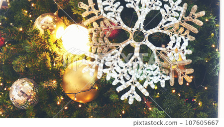 White snowflake colourful glittering baubles ornament ball decorated christmas tree. Holiday winter xmas happy new year festival decoration. Snowflake ball on Christmas tree. Merry Christmas decorate 107605667