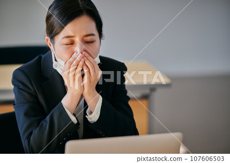 A young woman who can't stop sneezing or having a runny nose due to hay fever A young woman who can't stop sneezing or having a runny nose due to hay fever 107606503
