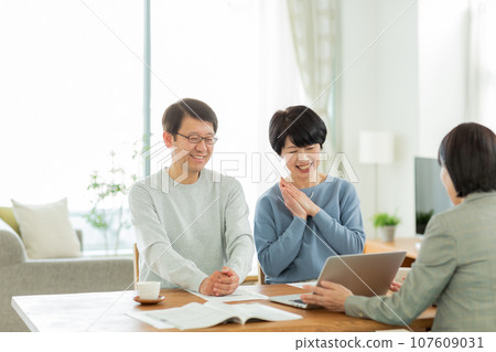 Senior couple and business woman having a business talk 107609031