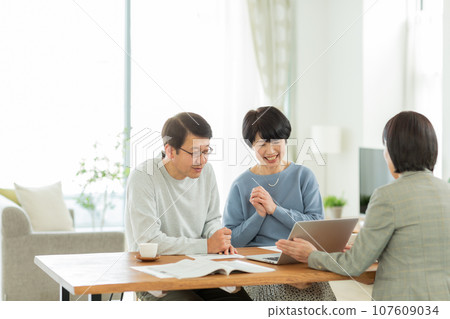 Senior couple and business woman having a business talk 107609034