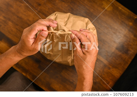 Untying and tying rice bags Untying and tying rice bags 107609213