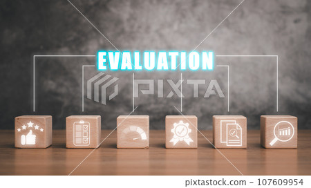 Evaluation concept, Wooden block on desk with evaluation icon on virtual screen. 107609954