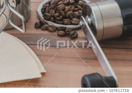 Coffee beans and coffee mill close-up material Coffee beans and coffee mill close-up material 107611728