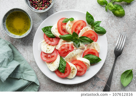 Caprese salad with tomatoes, mozzarella and basil. Caprese salad with tomatoes, mozzarella and basil. 107612816