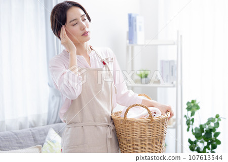 Housework: A woman who is unwell Housework: A woman who is unwell 107613544