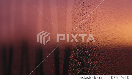Water drops on window glass with sunset light Water drops on window glass with sunset light 107617618