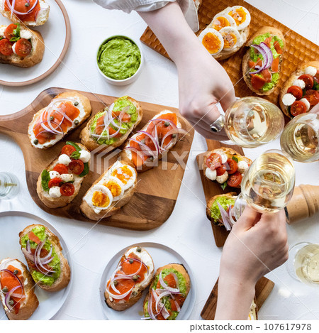 Toast with champagne at a home party Toast with champagne at a home party 107617978