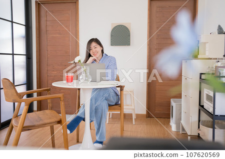asian woman freelancer relax and happy during working from home 107620569