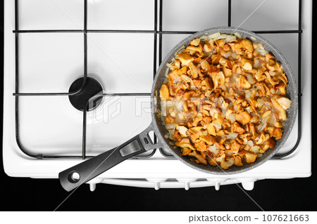 Frying chanterelle mushrooms in a pan Frying chanterelle mushrooms in a pan 107621663