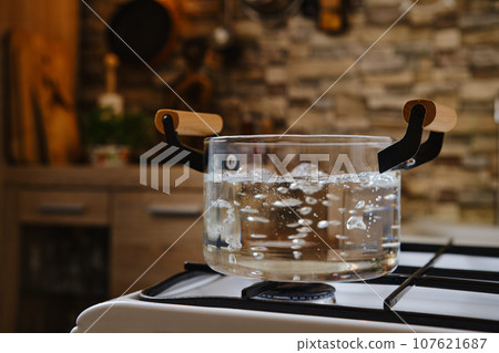 Water boiling in glass pot on stove Water boiling in glass pot on stove 107621687