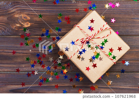 Simple christmas gift with red twine and decor stars 107621968
