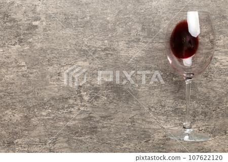 One glasses of red wine at wine tasting. Concept of red wine on colored background. Top view, flat lay design 107622120