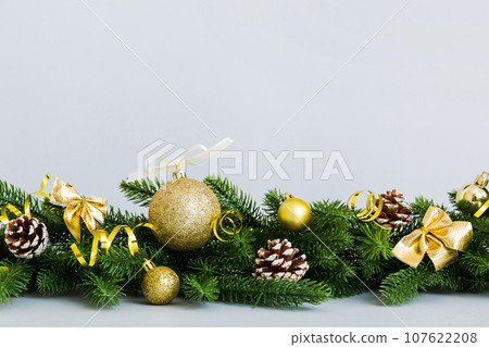 New Year Christmas tree toy, branches of a christmas tree, New Year decorations on a colored background New Year Christmas tree toy, branches of a christmas tree, New Year decorations on a colored background 107622208
