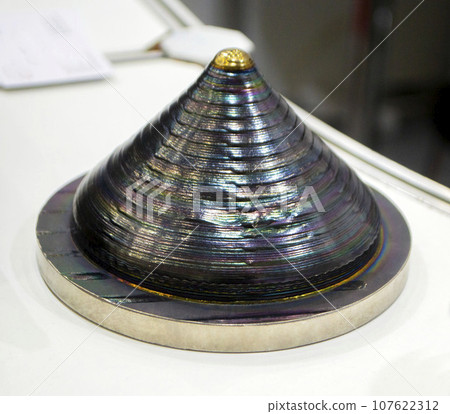 3d printed metal model close-up. Model printed on a 3D printer made of metal. Three-dimensional metal object created by a 3d printer from metal. 3D printing additive modeling manufacturing technology 3d printed metal model close-up. Model printed on a 3D printer made of metal. Three-dimensional metal object created by a 3d printer from metal. 3D printing additive modeling manufacturing technology 107622312