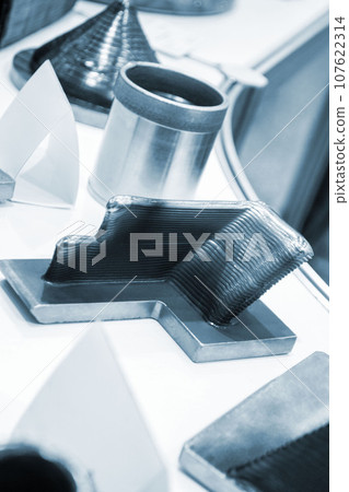 3d printed metal model close-up. Model printed on a 3D printer made of metal. Three-dimensional metal object created by a 3d printer from metal. 3D printing additive modeling manufacturing technology 3d printed metal model close-up. Model printed on a 3D printer made of metal. Three-dimensional metal object created by a 3d printer from metal. 3D printing additive modeling manufacturing technology 107622314