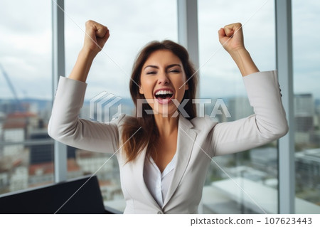 Happy businesswoman rejoices at a successful project 107623443
