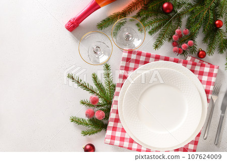 Christmas table setting with elegant red decorations on white table. View from above. 107624009