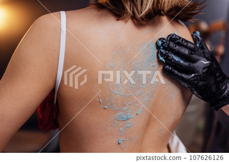 Young blonde woman makes cosmetology procedure in spa salon Young blonde woman makes cosmetology procedure in spa salon 107626126