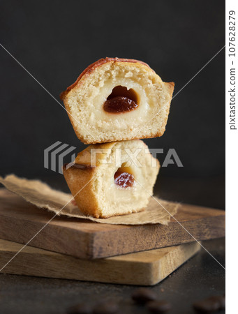 Pasticciotto leccese pastry filled with egg custard cream and sour cherry jam close up 107628279