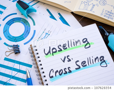 Notepad with inscriptions Upselling vs Cross-selling. Notepad with inscriptions Upselling vs Cross-selling. 107628354