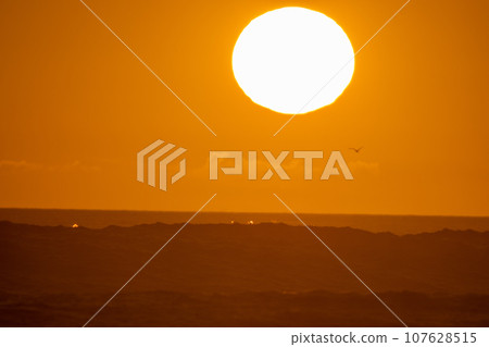 Orange sunset - bright big sun in the sky 107628515