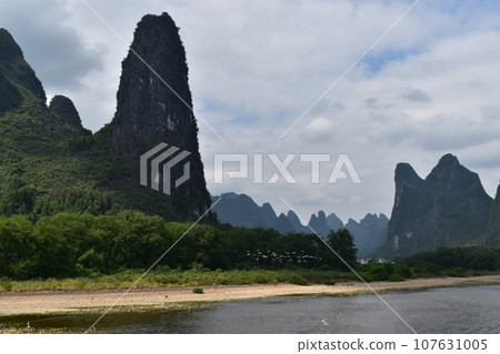 A fire in a landscape painting seen on the Li River, a world heritage site in Guilin, China 107631005